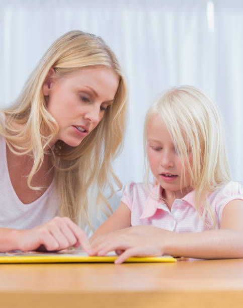 istock Mother and daughter reading together 828599472