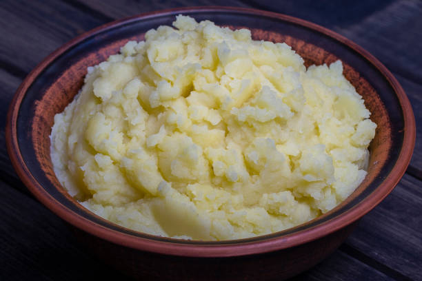 istock Mashed potatoes in a plate on the wooden table 828600194