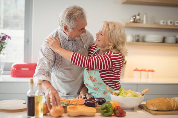 istock Senior couple embracing each other in kitchen 828606686