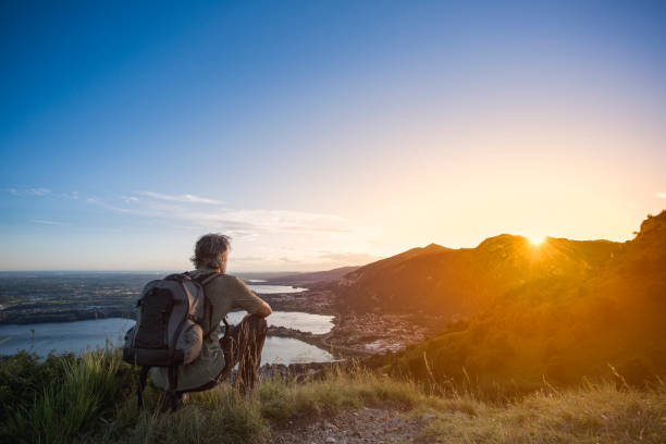 istock Hiker enjoying sunset on top of mountain 828610596