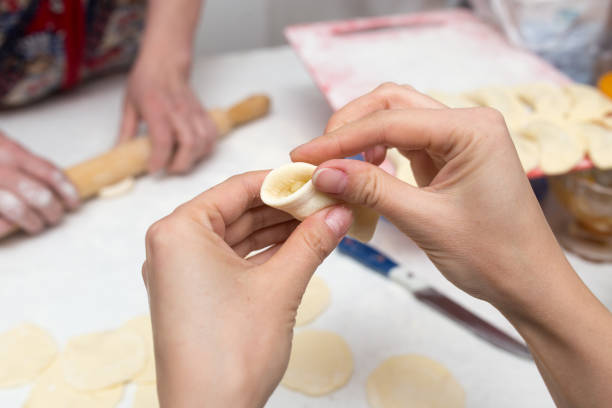 istock Cook cooks vareniki with potatoes 828610598