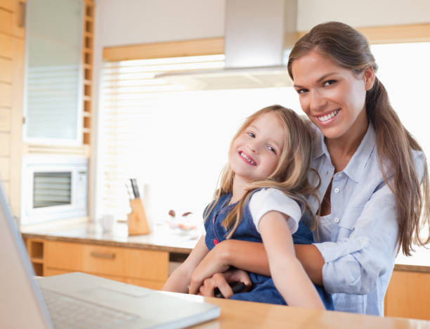 istock Happy mother and her daughter using a laptop 828636104