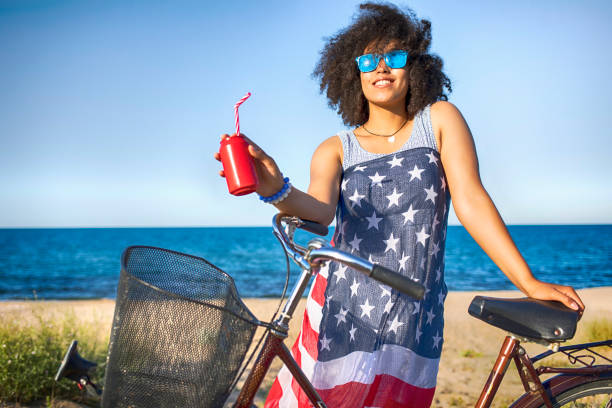 istock Woman with american flag drinking red cocktail 828641392