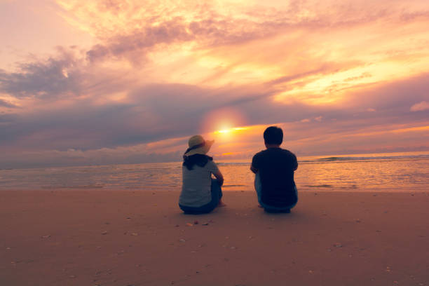 Couple on the beach at sunset time.