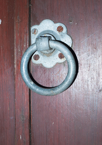 close of of a metal steel door handle on wooden gate; UK