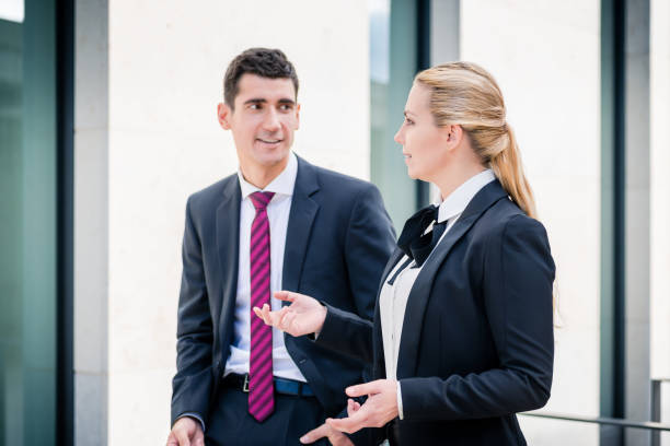istock Business man and woman discussing 828666944