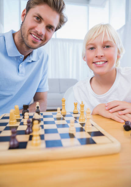 istock Father playing chess with his little boy 828669732