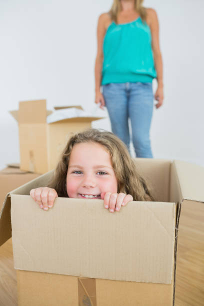 istock Laughing girl in moving box 828669822