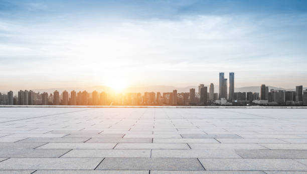 istock empty concrete road and cityscape in blue sky at dawn 828674542