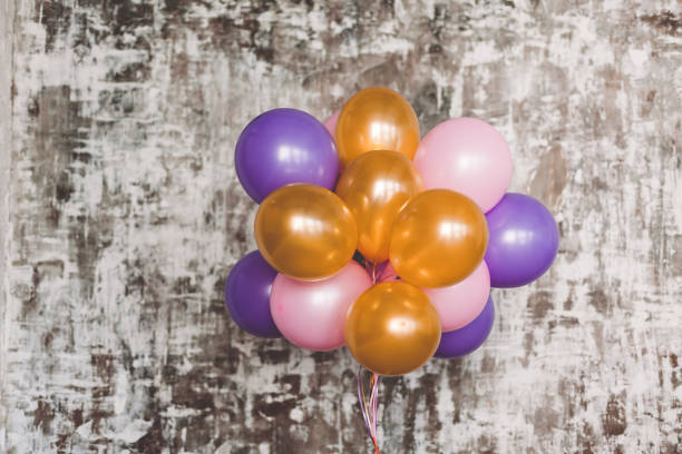 istock Bright balloons bunch against a textured wall 828690122