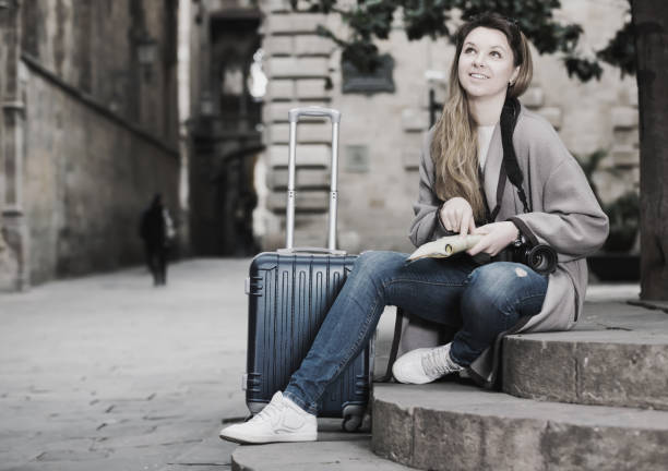 istock Blond cheerful girl holding brochure 828695324
