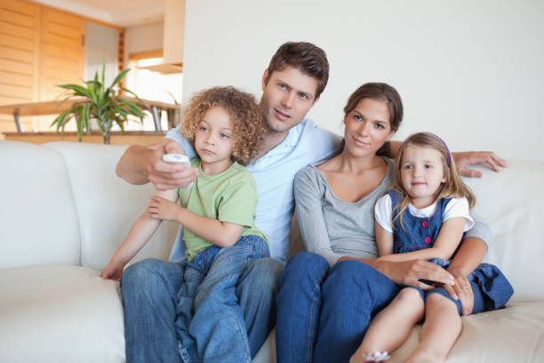 istock Family watching TV together 828708232