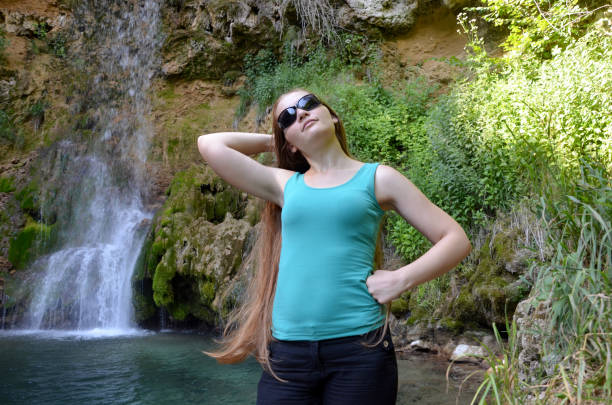 istock Girl and  the waterfall 828713162