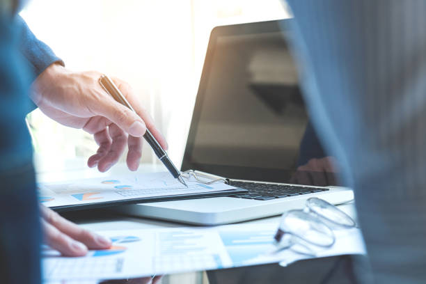 istock Business team two colleagues discussing new plan financial graph data on office table with laptop and digital tablet 828719312