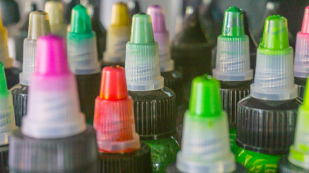 istock Multiple bottles with colorful inks for tattoo. Side view. Close-up 828727700