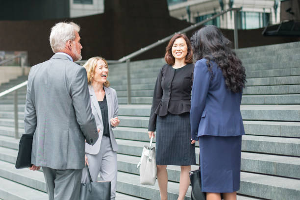 istock Business colleagues laughing and talking on steps 828739296