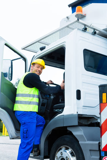 istock crane operator driving with truck of construction site 828748184
