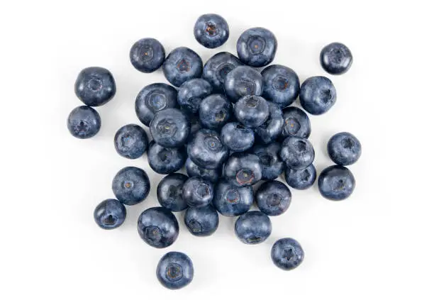 Pile of fresh blueberries over white background.
