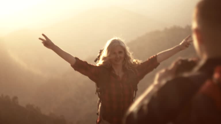 Active retired woman hiker posing for photo on mountain top