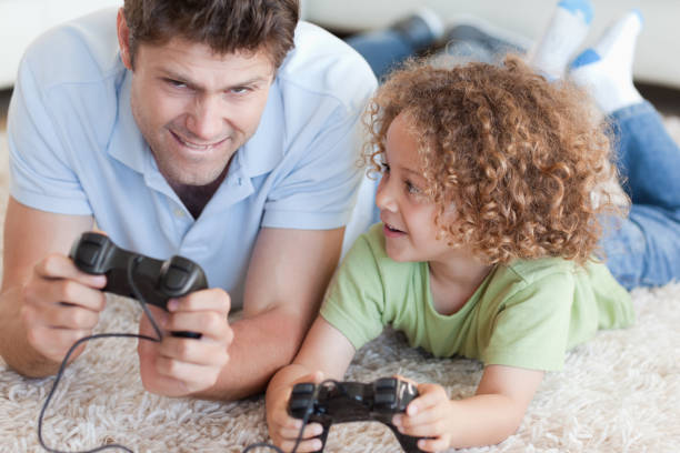 istock Boy and his father playing video games 828767206