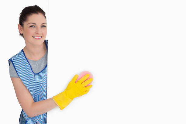 istock Smiling cleaner washing with a sponge 828770960