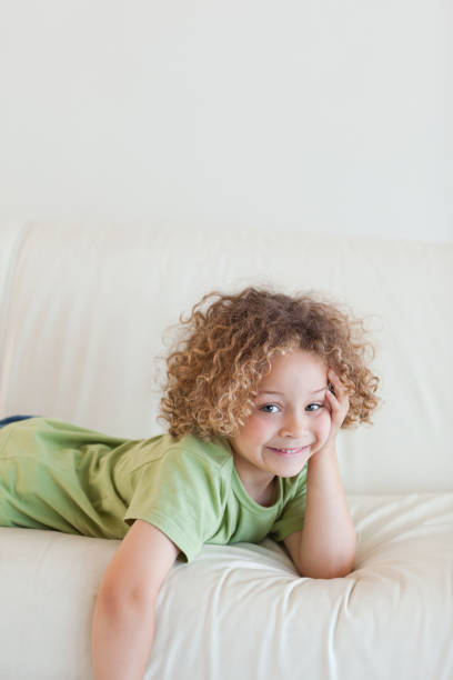 istock Portrait of a boy lying on a sofa 828774590