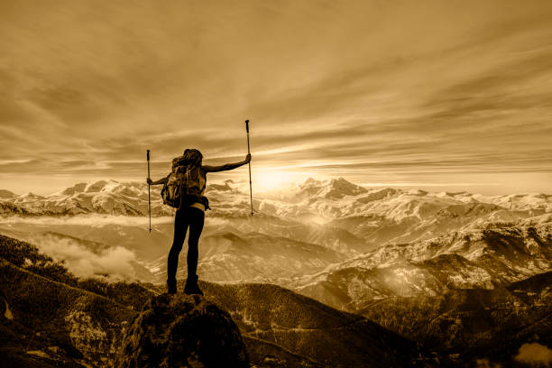 istock Female Hiker Silhouette at mountain peak 828779212
