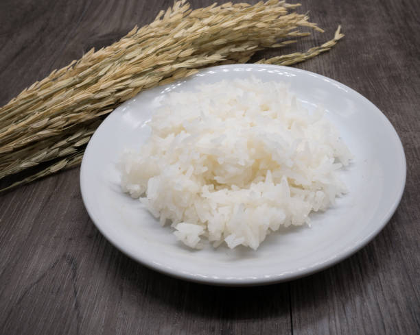 istock Close up rice in white plate on grey wooden background,table 828782346
