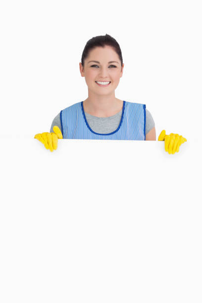 istock Cleaning woman showing a white panel 828800500