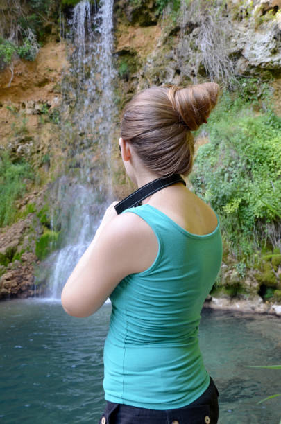 istock Beautiful girl looking waterfall Lisine 828803156