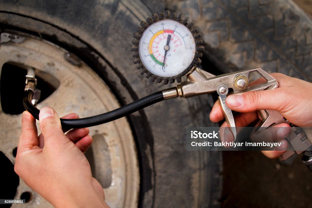hand and car wheel add air pressure Arm swing tire pressure Black Color Stock Photo