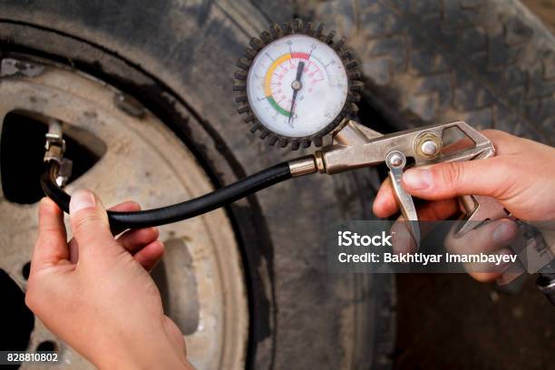 Hand And Car Wheel Add Air Pressure Stock Photo - Download Image Now - Black Color, Car, Close-up
