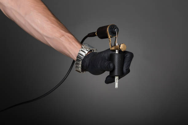 istock tattoo artist with tattoo equipment 828818666