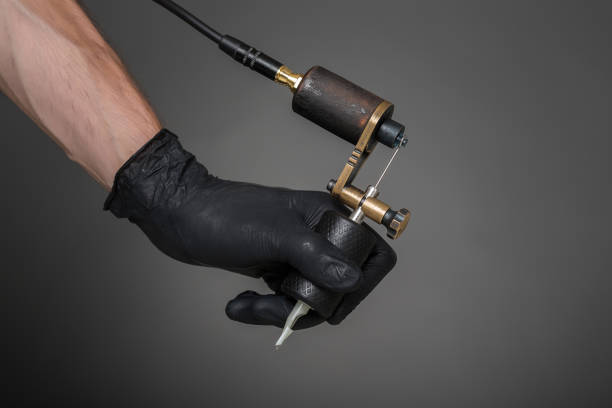 istock tattoo artist with tattoo equipment 828818678