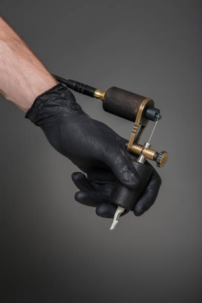 istock tattoo artist with tattoo equipment 828818714