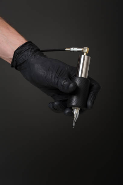 istock tattoo artist with tattoo equipment 828818868
