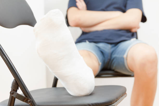 istock Man with broken leg in a plaster on white background 828820182