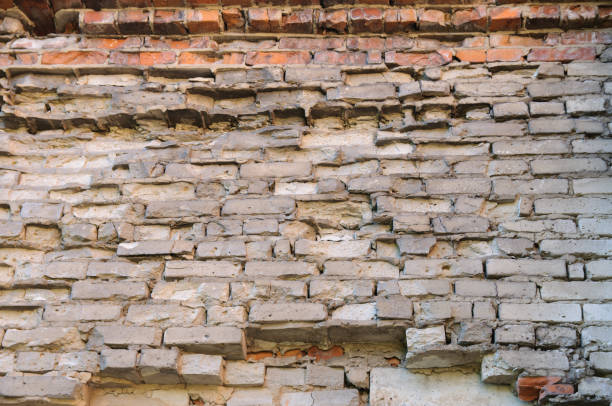 istock Background of old vintage dirty brick wall with peeling plaster, texture 828824730