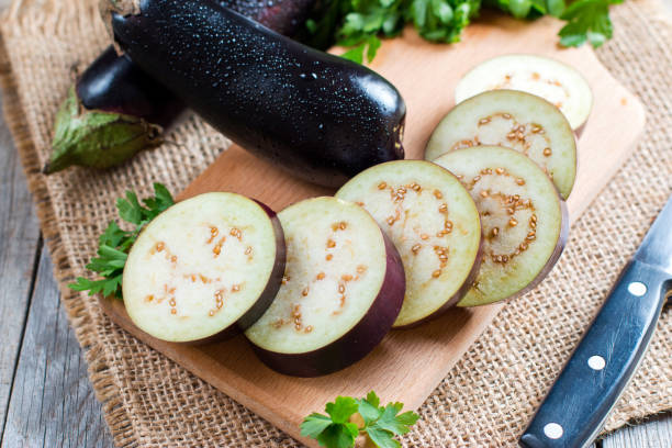 istock Eggplant lay on a cutting board, sliced and whole 828825734