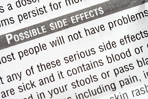 A close-up of the small text of medicine documentation, with the heading 'Possible side effects'.