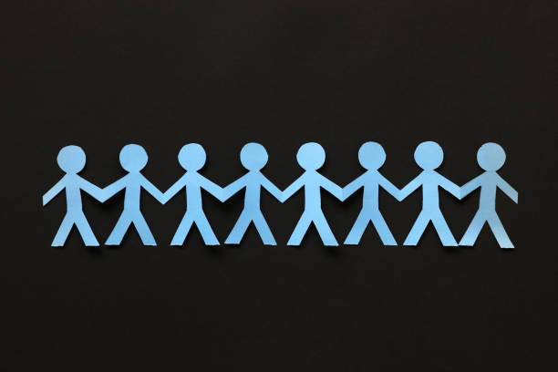 istock Paper people on the black paper background 828838668
