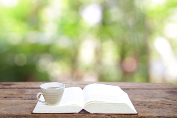 istock Notebook  and tea cup in cup on wooden table 828839866