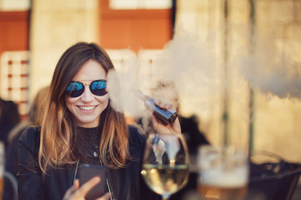 Woman with electronic cigarette stock photo