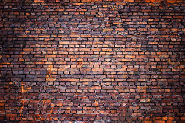 istock Antique brick wall vintage texture of red stone blocks as background 828852388