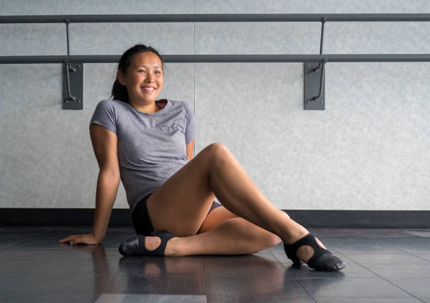 Smiling Jazz Dancer wearing T-strap jazz shoes Jazz dancer sitting in class listening to instructions jazz dancing stock pictures, royalty-free photos & images