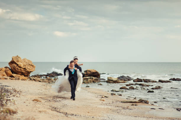 The wedding couple on a walk by the sea
