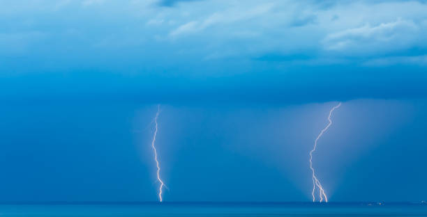 istock Thunder storm lightning strike on the sea  background at night. 828861224