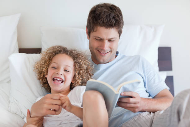 istock Father reading bedtime story for child 828861440