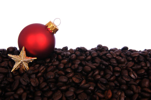 Red Holiday ball and gold star on coffee on a white background.