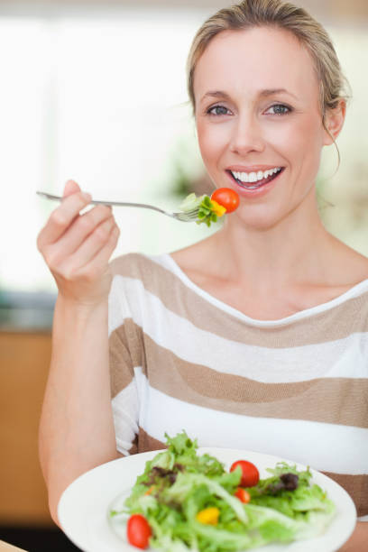 istock Woman eating some salad 828869566